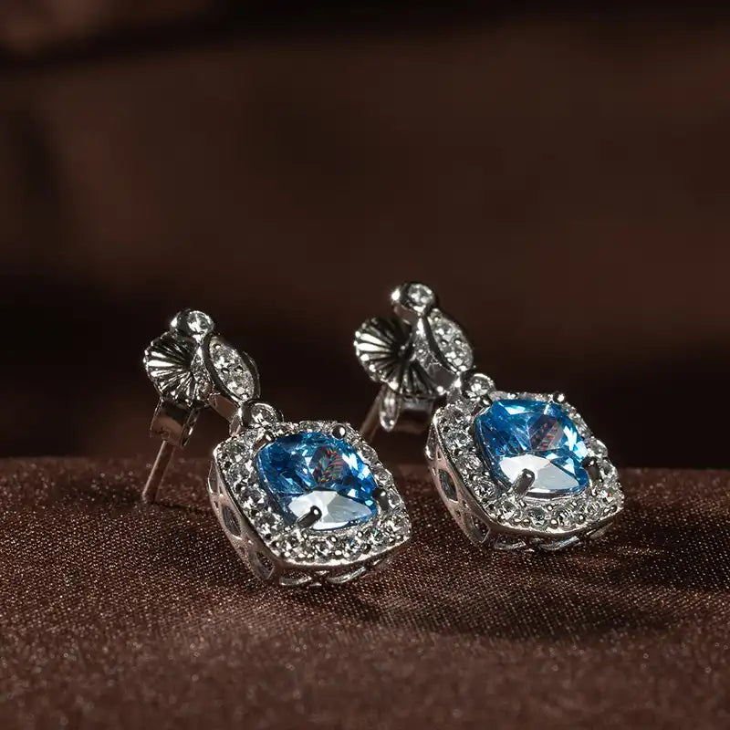 Winter Diamond™ Earrings — 18K White Gold | Cushion Blue Topaz